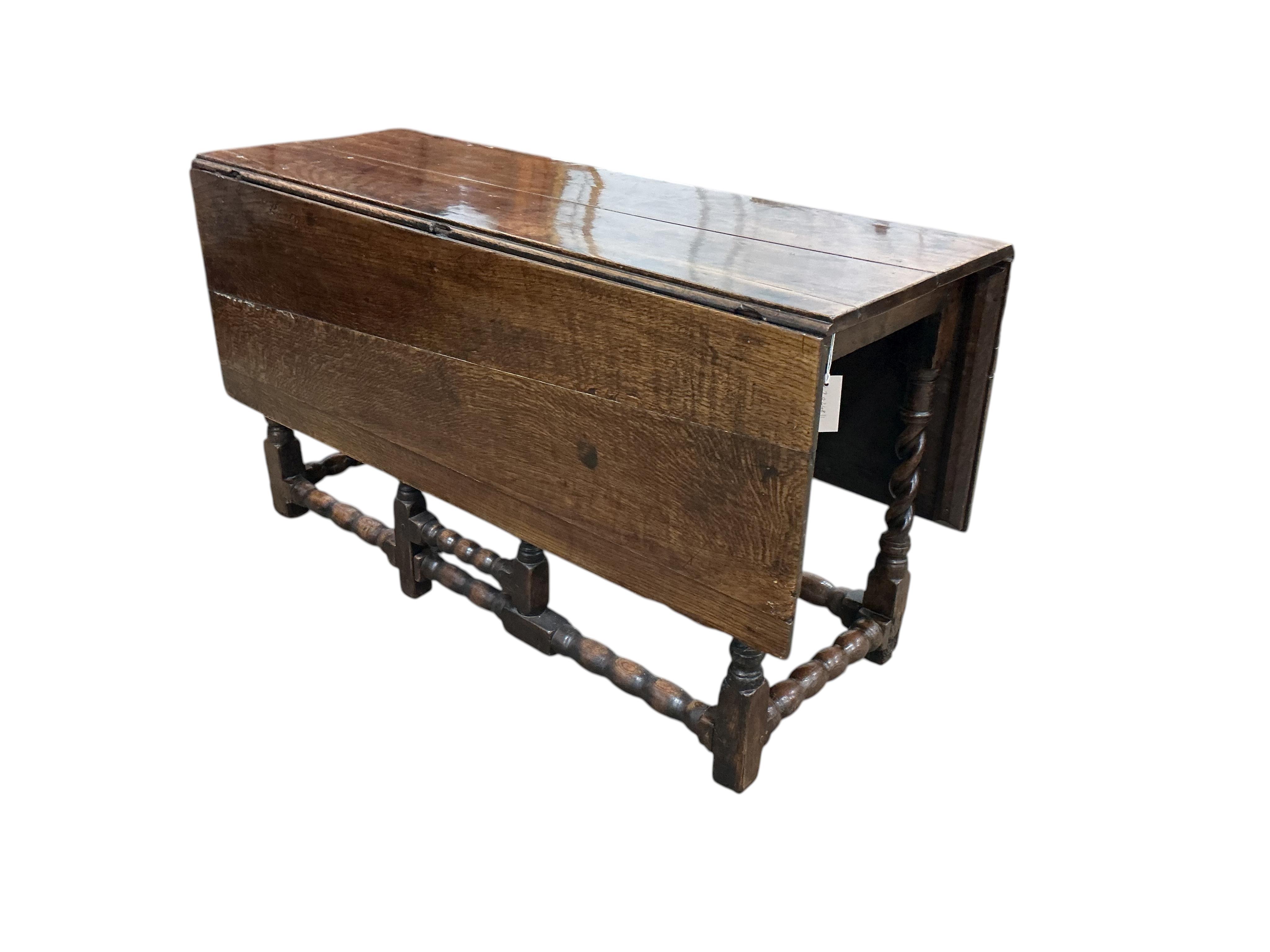 A late 17th / early 18th century oak gateleg table with barley twist legs, width 134cm, length 140cm extended, height 73cm